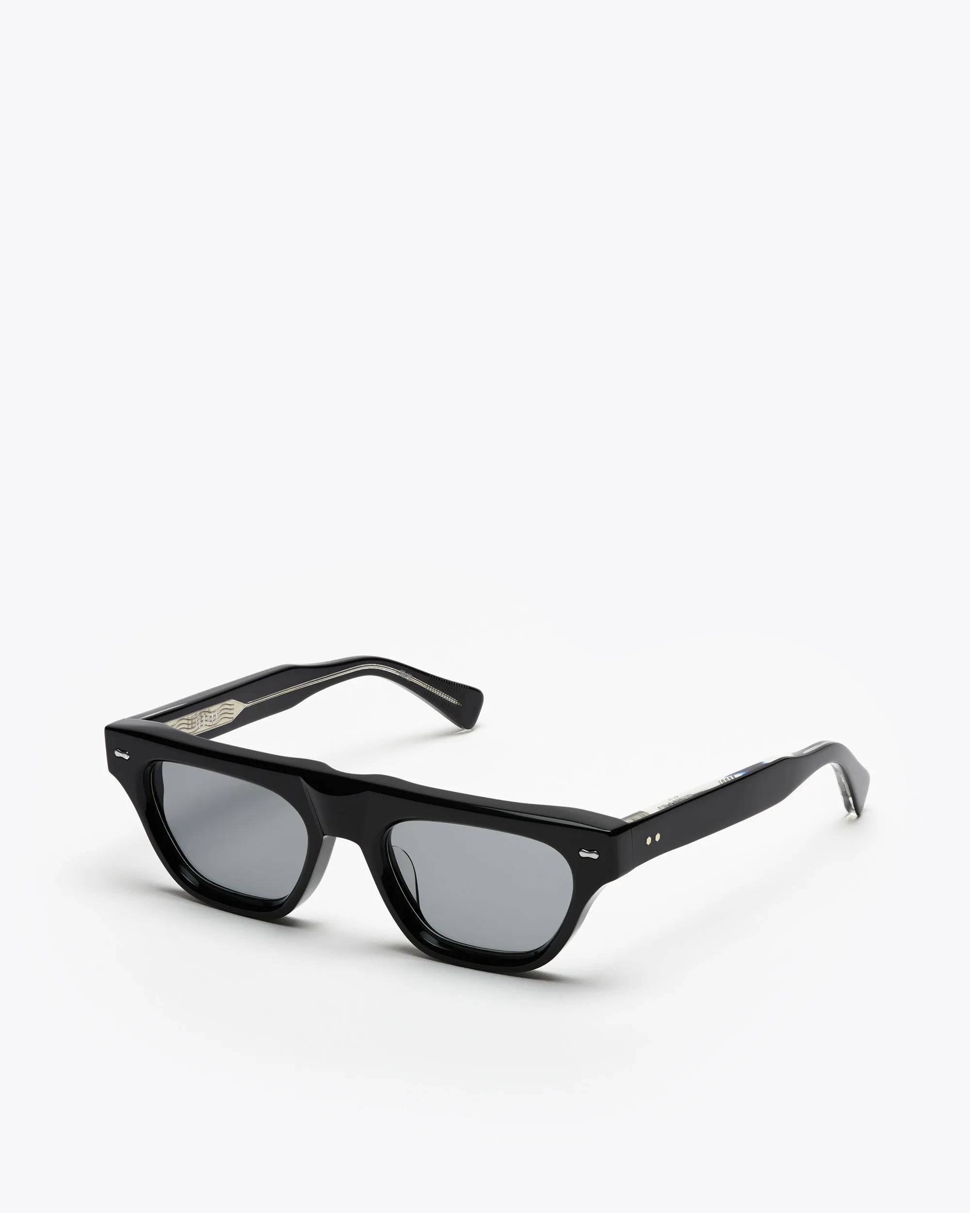 Black framed cat-eye sunglasses with grey lenses on a white background