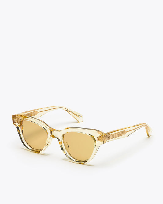 Yellow translucent cat-eye sunglasses with champagne yellow lenses on a white background