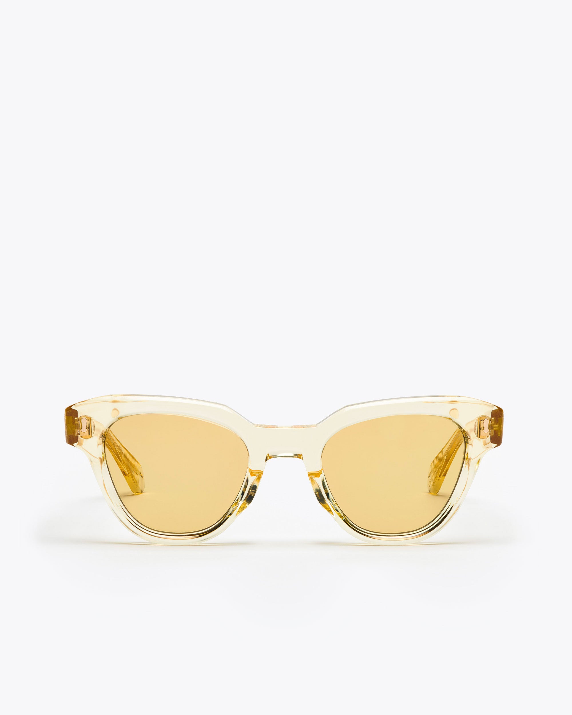 Yellow translucent cat-eye sunglasses with champagne yellow lenses on a white background