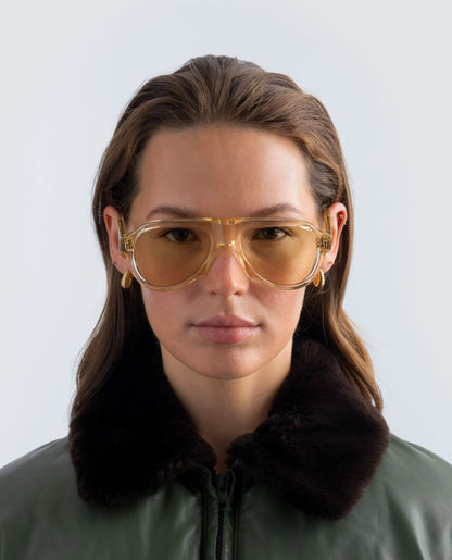 Woman wearing Yellow Zephyr aviator sunglasses with a neutral background