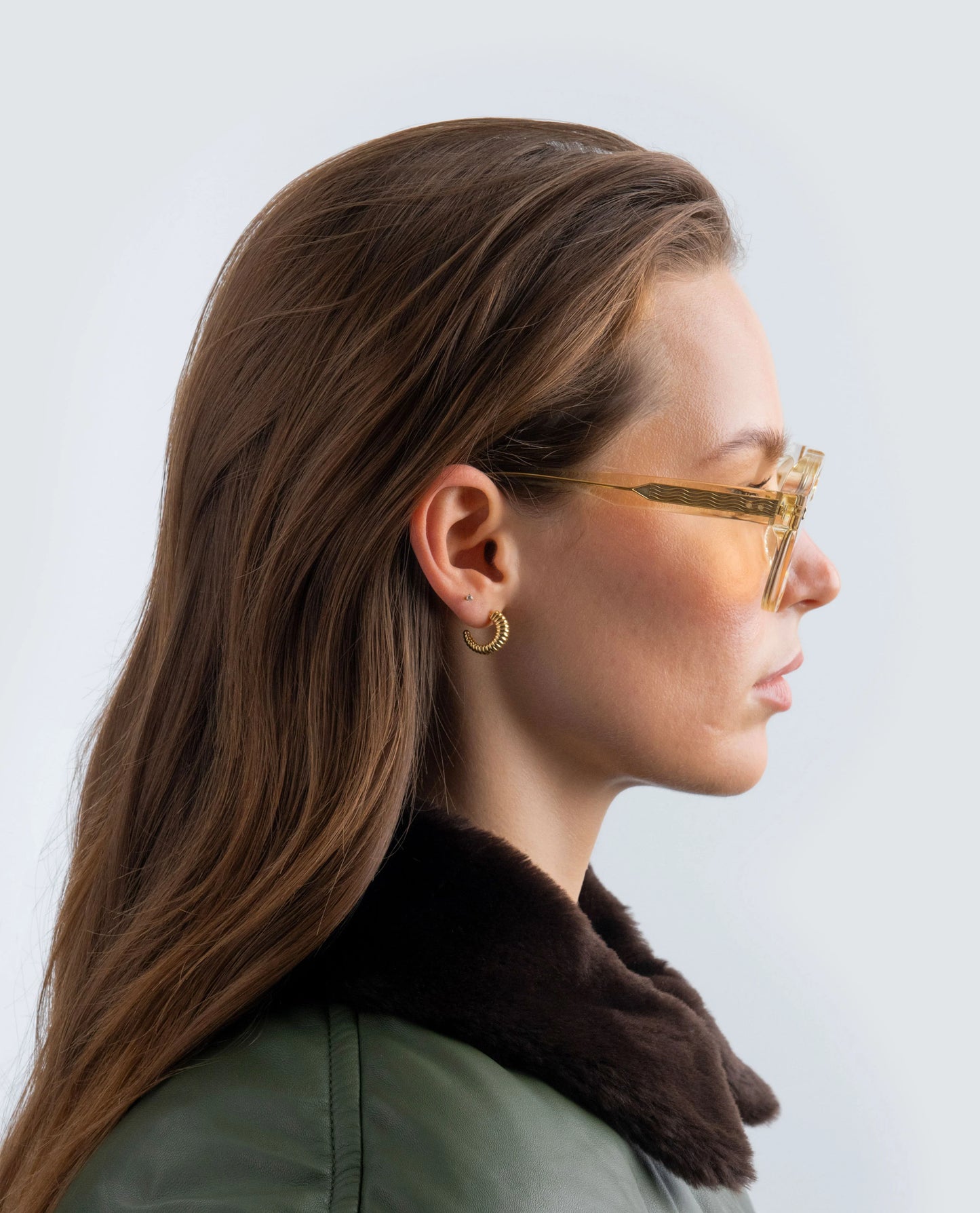 Woman wearing Yellow Zephyr aviator sunglasses with a neutral background