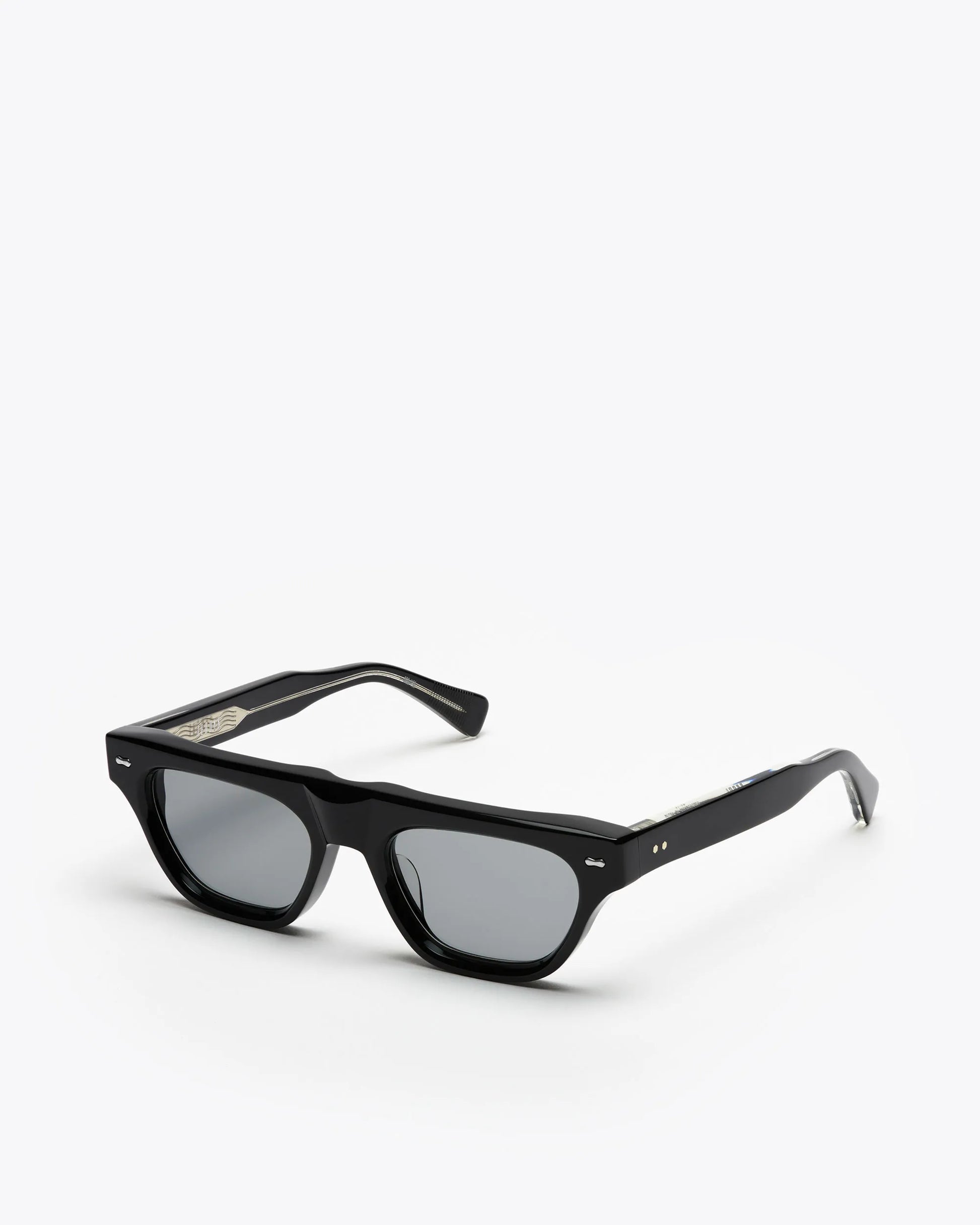 Black framed cat-eye sunglasses with grey lenses on a white background