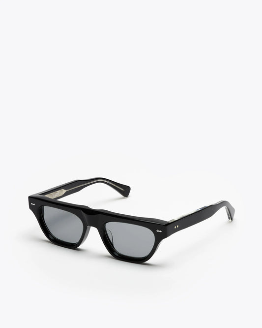Black framed cat-eye sunglasses with grey lenses on a white background