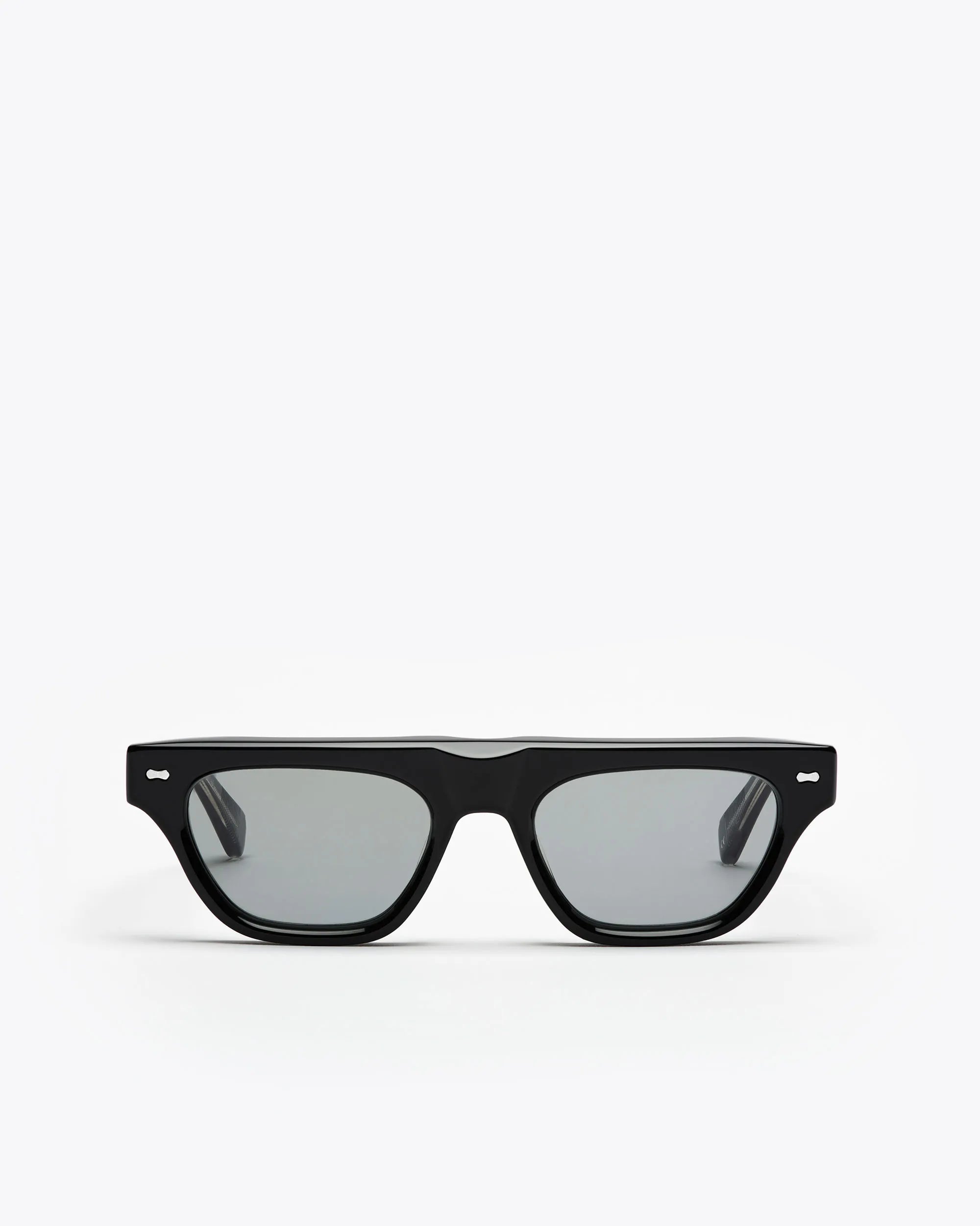 Black framed cat-eye sunglasses with grey lenses on a white background