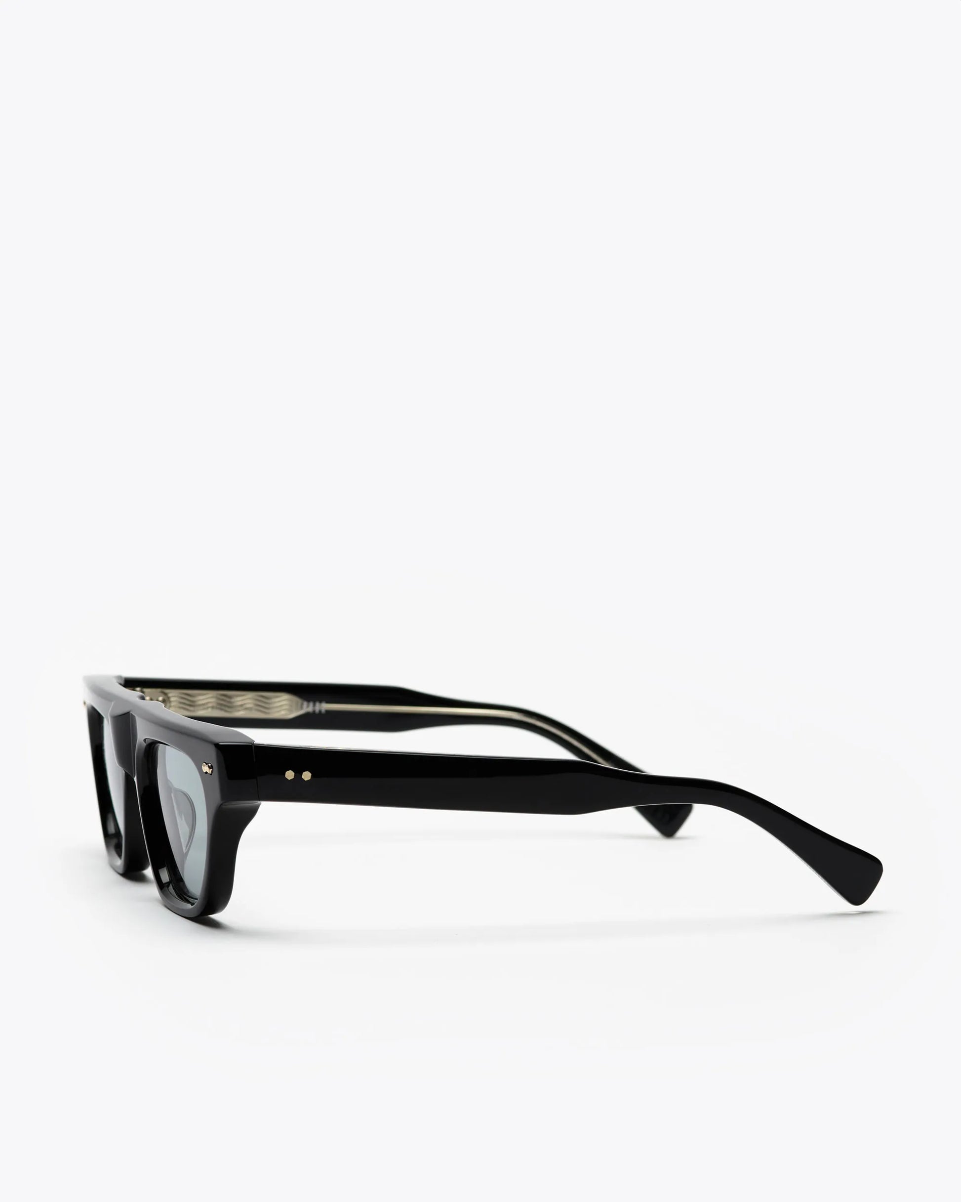 Black framed cat-eye sunglasses with grey lenses, on a white background