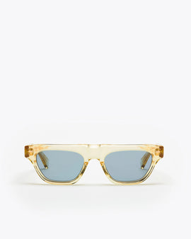 Rectangular-shaped sunglasses with a champagne yellow frame and blue lenses on a white background