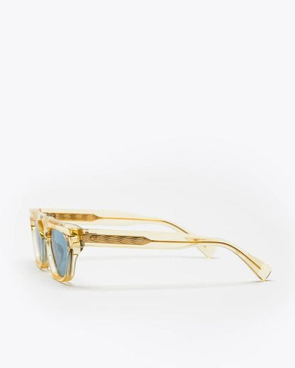 Rectangular-shaped sunglasses with a champagne yellow frame and blue lenses on a white background
