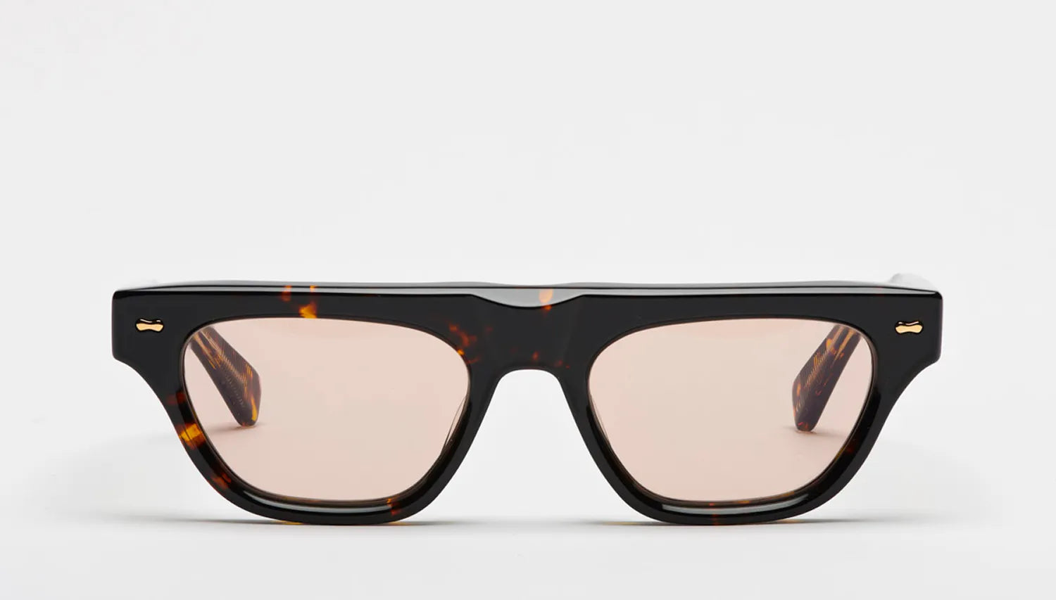 Sunglasses with a tortoiseshell frame and brown lenses on a white background