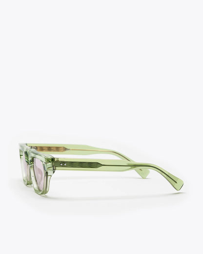 Rectangular-shaped sunglasses with seafoam green frame and lilac lenses on a white background