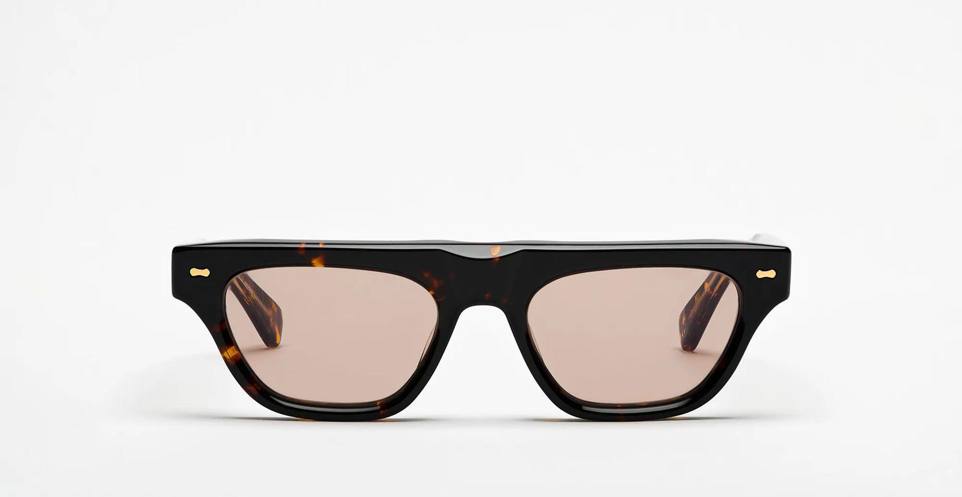 Sunglasses with a tortoiseshell frame and brown lenses on a white background