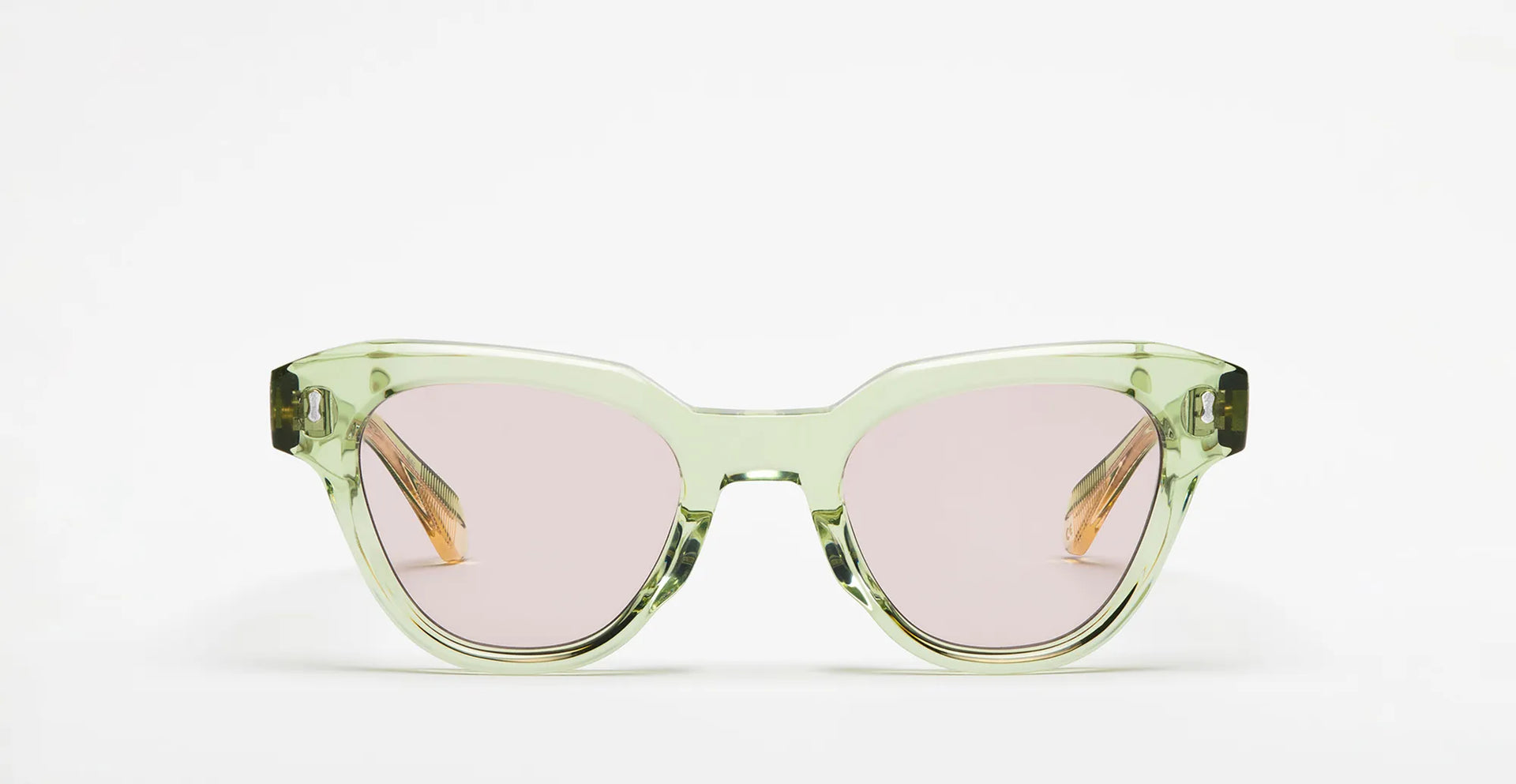 Seafoam green sunglasses with lilac lenses on a white background