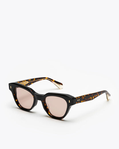 Tortoiseshell cat-eye sunglasses with brown lenses on a white background