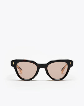 Tortoiseshell cat-eye sunglasses with brown lenses on a white background