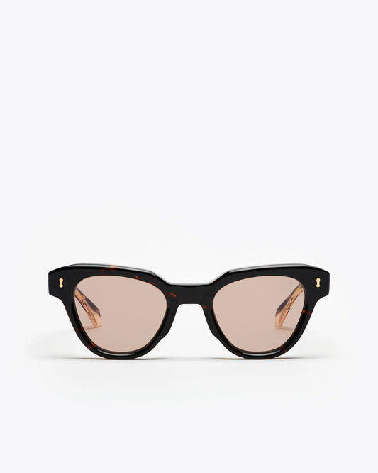 Tortoiseshell cat-eye sunglasses with brown lenses on a white background