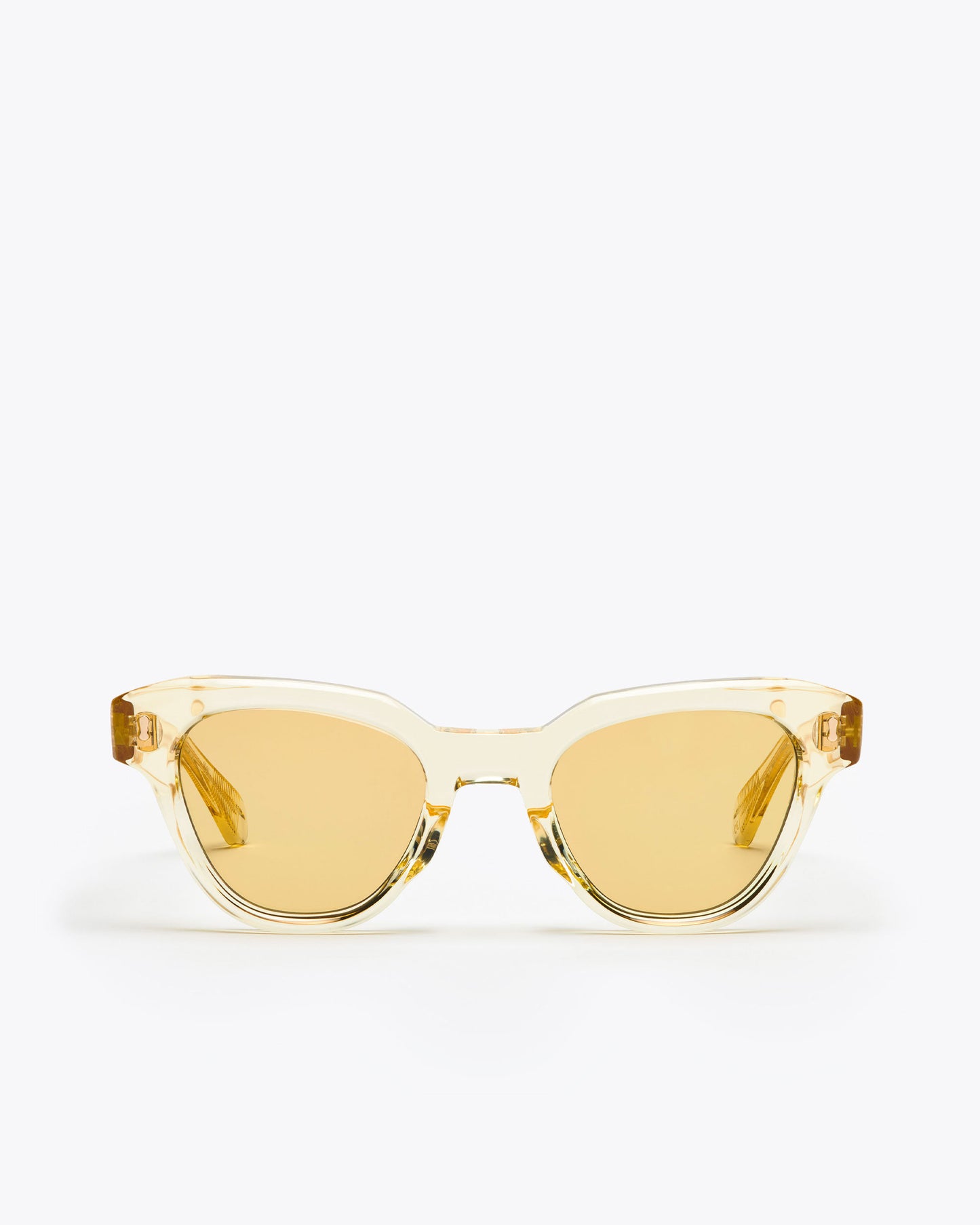 Yellow translucent cat-eye sunglasses with champagne yellow lenses on a white background