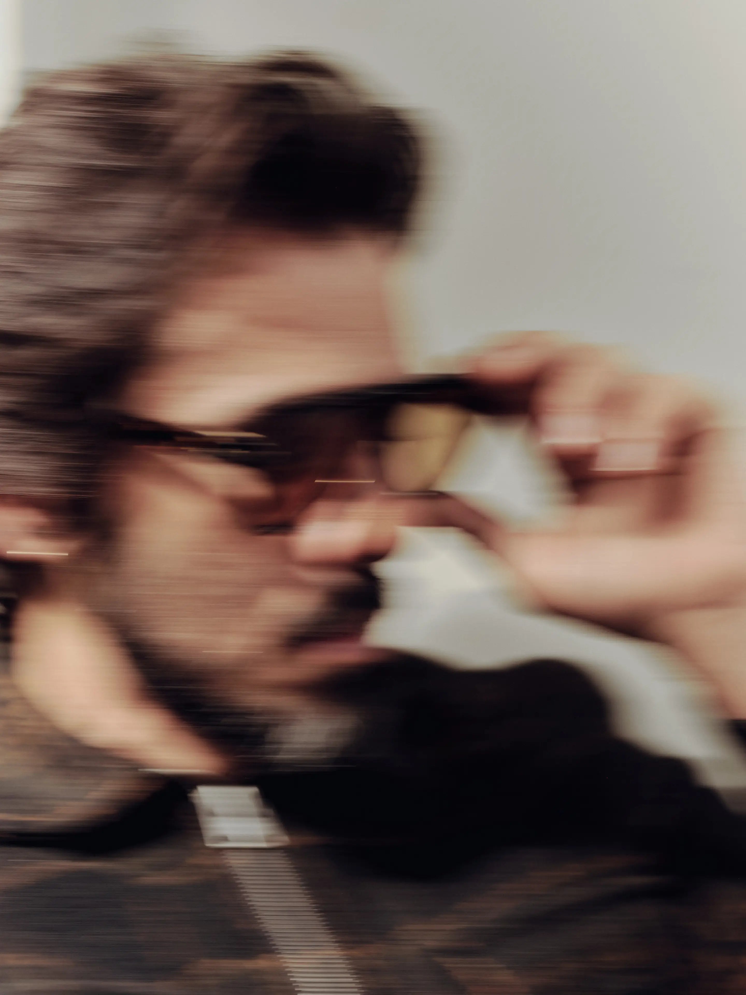 Blurry image of a man wearing sunglasses