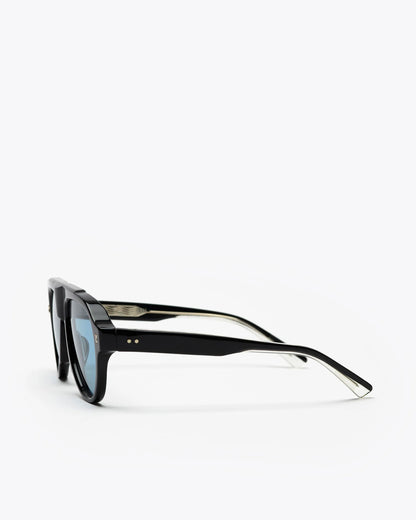 Aviator style sunglasses with black frames and blue lenses on a white background