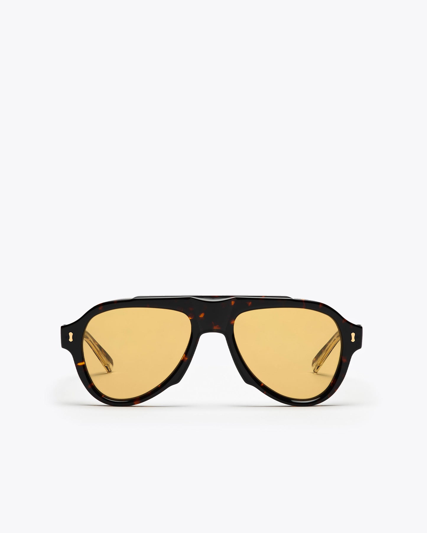 Sunglasses with tortoiseshell frame and amber lenses on a white background