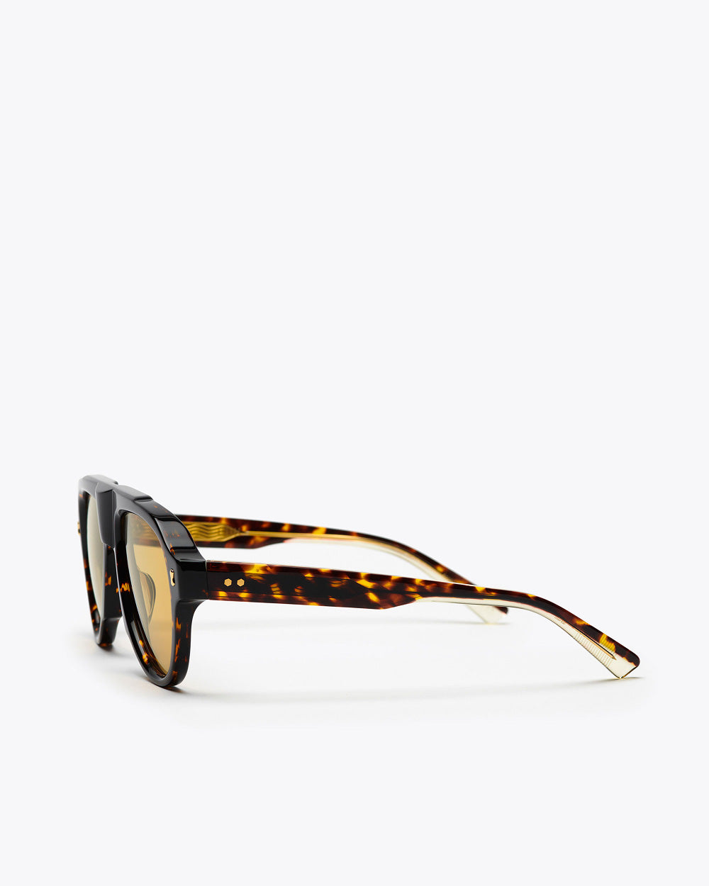 Tortoiseshell sunglasses with amber lenses, sideways, on a white background
