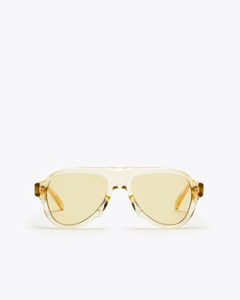 Champagne yellow-framed sunglasses with yellow-tinted lenses on a white background
