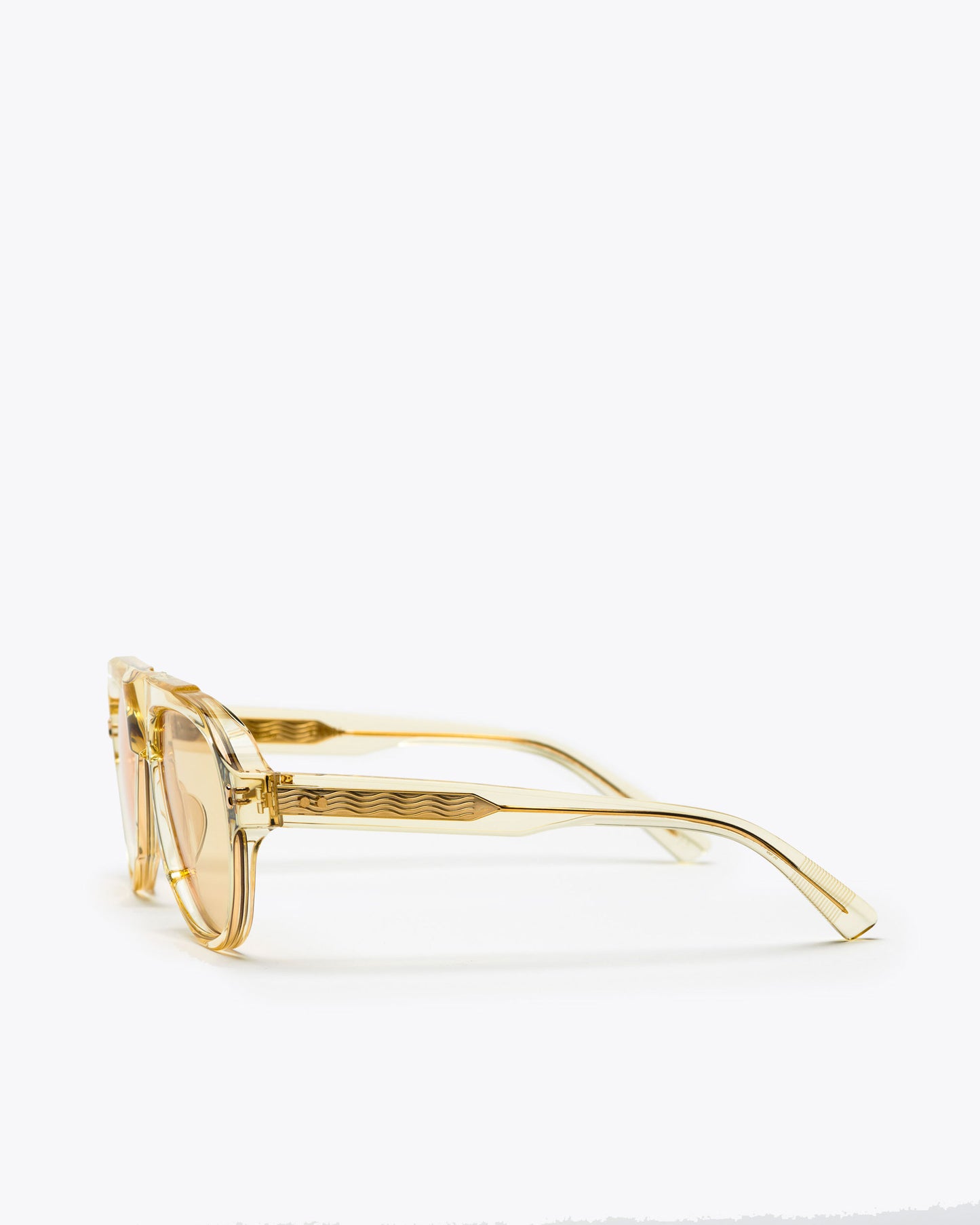 Champagne yellow-framed sunglasses with yellow-tinted lenses on a white background